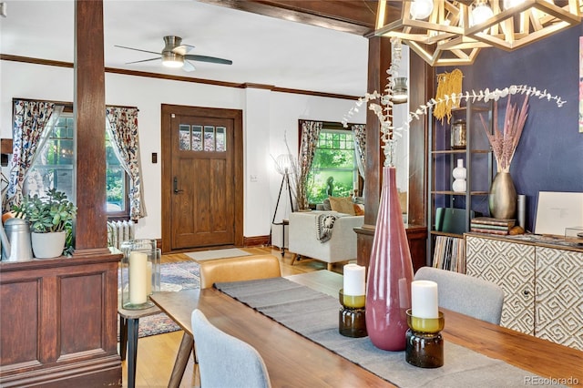 2236 Forest St, Denver, CO 80207 - entryway featuring wood finished floors, ornamental molding, a ceiling fan, and a chandelier