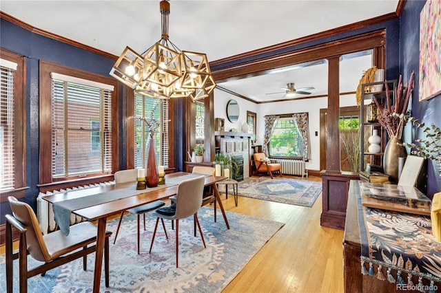2236 Forest St, Denver, CO 80207 - dining room with radiator heating unit, crown molding, wood-type flooring, a chandelier, and baseboards
