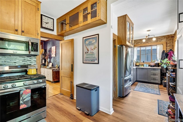 2236 Forest St, Denver, CO 80207 - kitchen with stainless steel appliances, light wood-type flooring, backsplash, glass insert cabinets, and crown molding