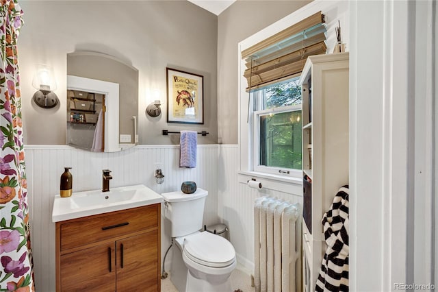 2236 Forest St, Denver, CO 80207 - full bathroom featuring radiator, wainscoting, vanity, and toilet