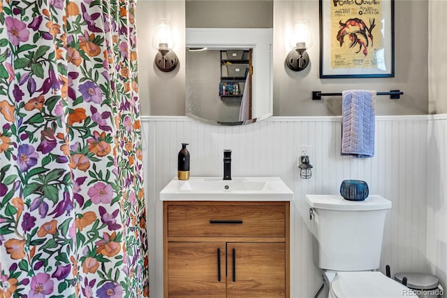 2236 Forest St, Denver, CO 80207 - bathroom featuring wainscoting, vanity, and toilet