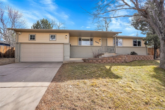 ranch-style home featuring a garage and a front lawn