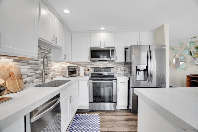 kitchen featuring sink, stainless steel appliances, and white cabinets