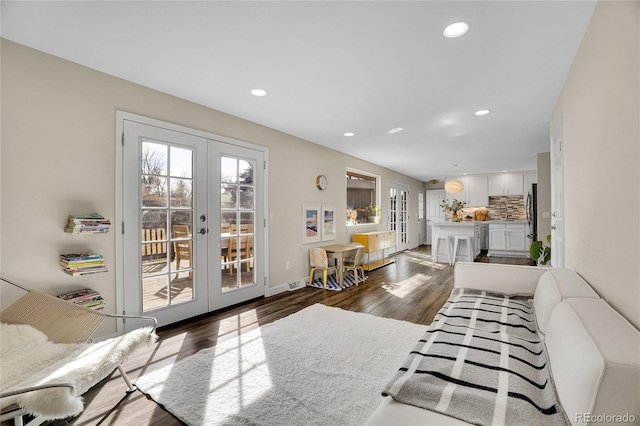 living room featuring french doors and dark hardwood / wood-style flooring