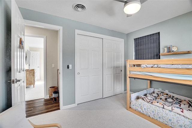 carpeted bedroom featuring ceiling fan and a closet