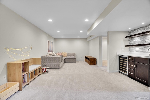 carpeted living room featuring wet bar and beverage cooler