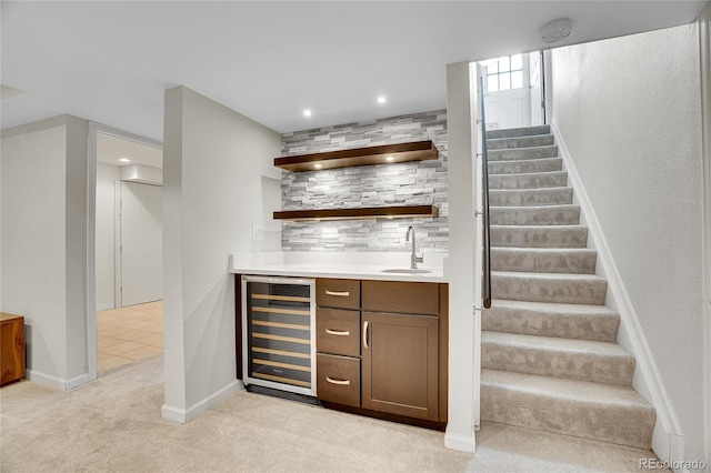 bar with wine cooler, sink, and light carpet