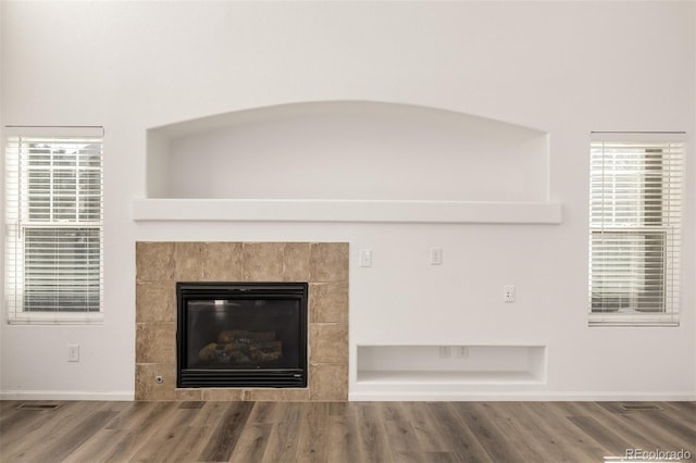 interior details featuring hardwood / wood-style flooring and a fireplace