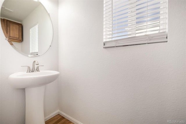 bathroom with sink and hardwood / wood-style flooring