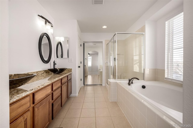 bathroom featuring tile patterned flooring, vanity, and shower with separate bathtub