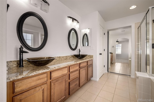 bathroom with vanity, an enclosed shower, and tile patterned floors