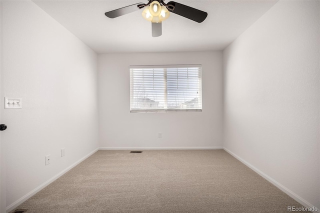 empty room featuring carpet flooring and ceiling fan