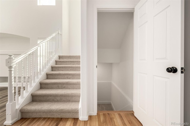 stairs featuring hardwood / wood-style flooring