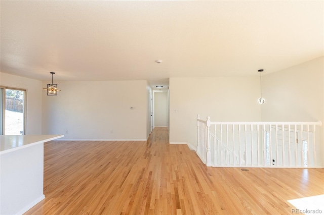 empty room with light wood-type flooring and baseboards