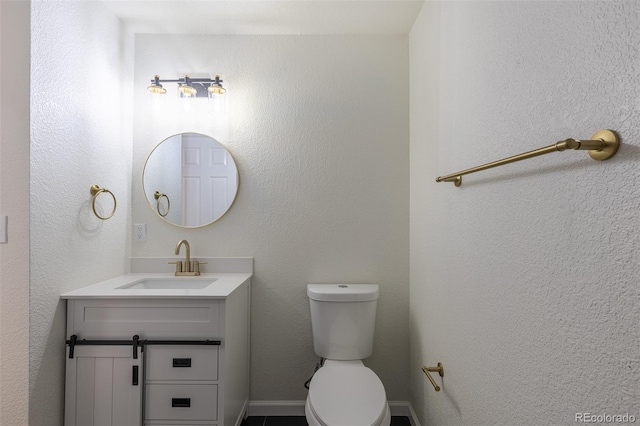 bathroom featuring toilet and vanity