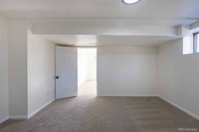 carpeted empty room with baseboards