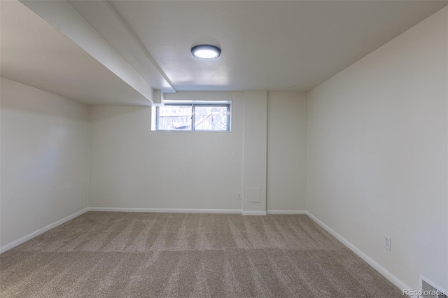 unfurnished room with carpet floors and baseboards