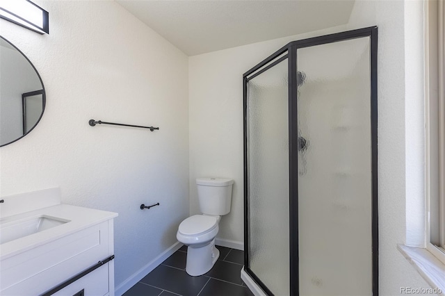 bathroom with toilet, vanity, baseboards, tile patterned floors, and a stall shower