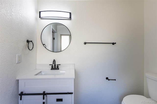 bathroom with toilet and vanity