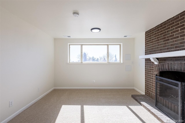 unfurnished living room with carpet, a brick fireplace, visible vents, and baseboards