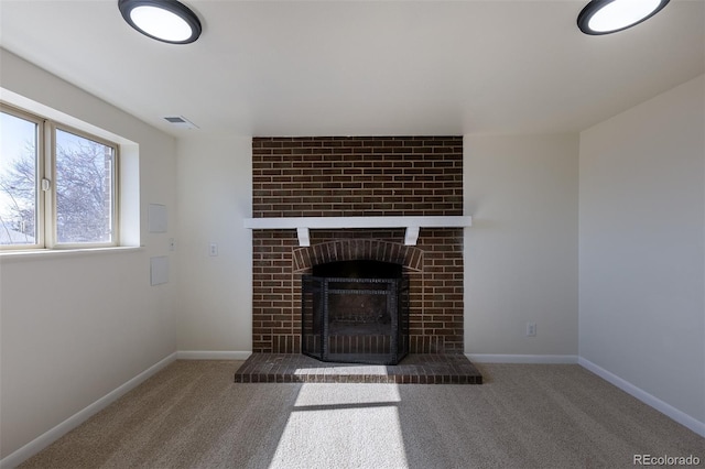 unfurnished living room featuring carpet floors, visible vents, a fireplace, and baseboards