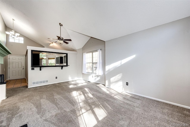 unfurnished living room featuring high vaulted ceiling, ceiling fan with notable chandelier, and carpet