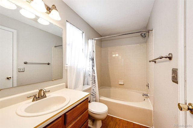 full bathroom with shower / bath combination with curtain, toilet, hardwood / wood-style flooring, and vanity