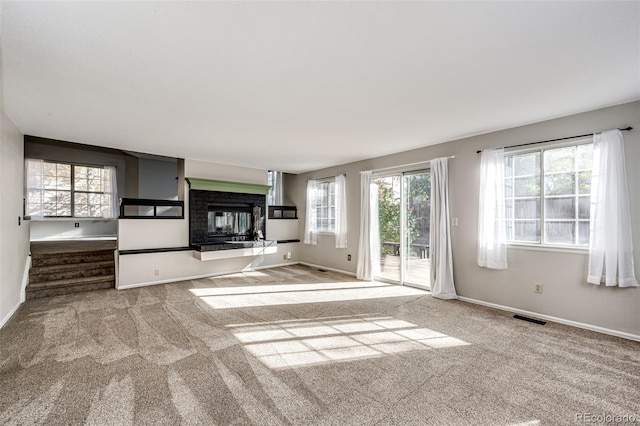 unfurnished living room featuring light carpet