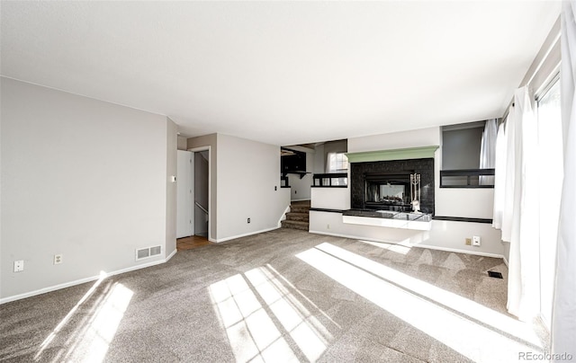 unfurnished living room featuring carpet flooring