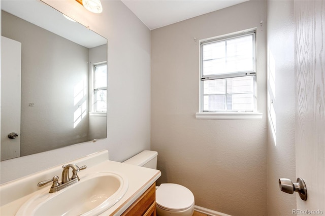 bathroom featuring toilet and vanity