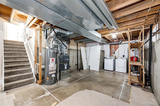 basement with heating unit, separate washer and dryer, and gas water heater