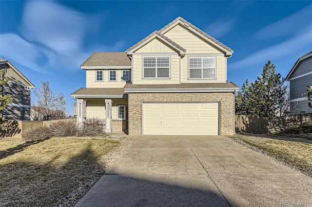 view of front of home with brick siding, fence, a tiled roof, concrete driveway, and an attached garage