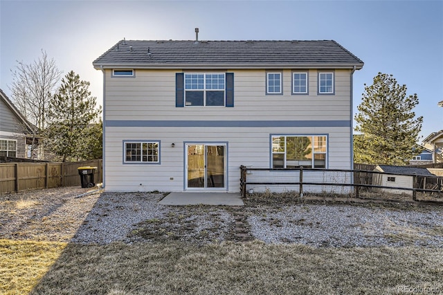 back of house featuring a patio and a fenced backyard