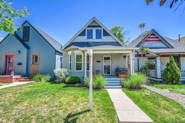 1208 S Pennsylvania St, Denver, CO 80210 - view of front of home with covered porch and a front lawn
