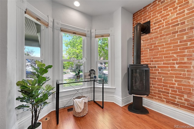 1208 S Pennsylvania St, Denver, CO 80210 - office space with wood finished floors, baseboards, plenty of natural light, and a wood stove