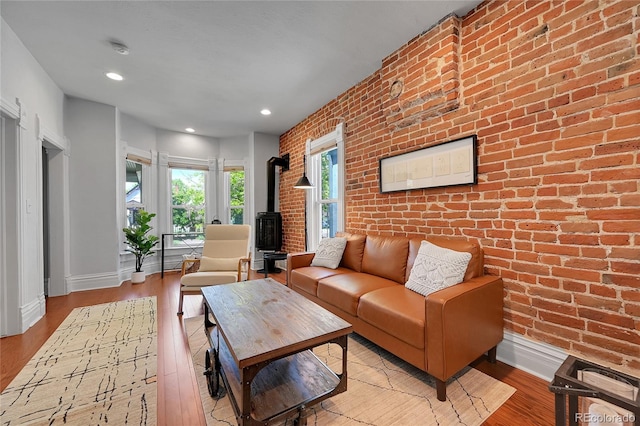1208 S Pennsylvania St, Denver, CO 80210 - living area featuring a wood stove, brick wall, baseboards, wood finished floors, and recessed lighting