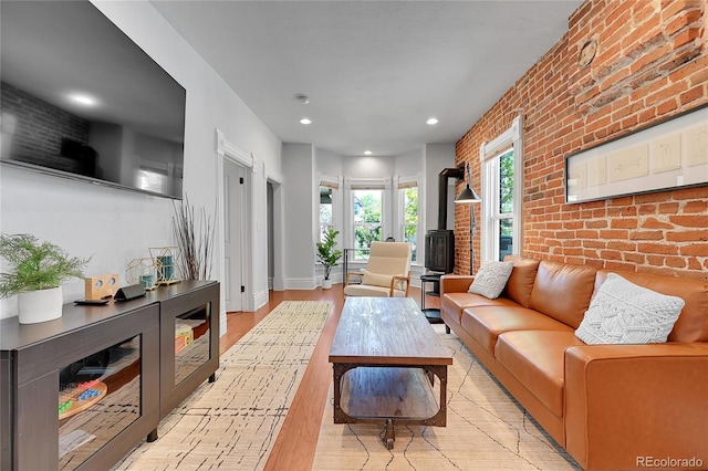 1208 S Pennsylvania St, Denver, CO 80210 - living area with brick wall, recessed lighting, light wood-style floors, and baseboards