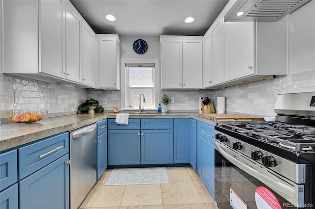 1208 S Pennsylvania St, Denver, CO 80210 - kitchen featuring appliances with stainless steel finishes, a sink, blue cabinetry, ventilation hood, and white cabinets