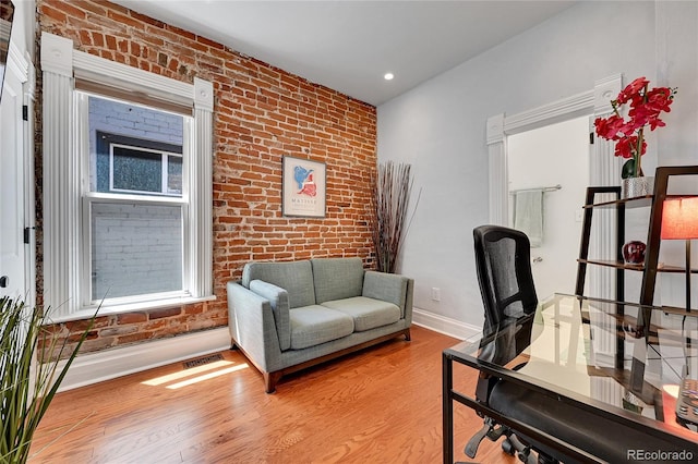 1208 S Pennsylvania St, Denver, CO 80210 - home office featuring wood finished floors, brick wall, baseboards, and recessed lighting