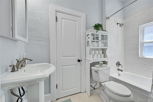 1208 S Pennsylvania St, Denver, CO 80210 - full bath featuring toilet, tub / shower combination, a sink, tile patterned flooring, and a textured wall