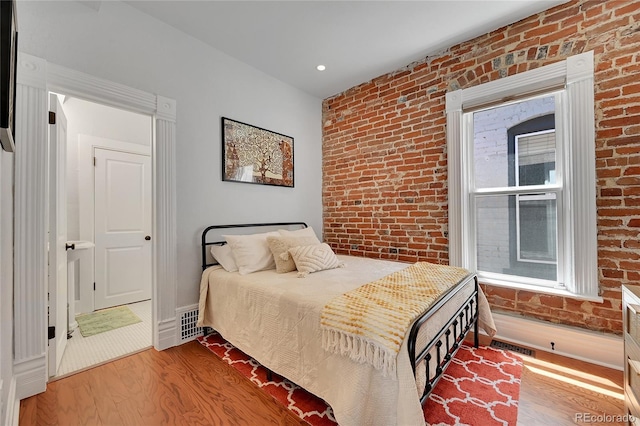 1208 S Pennsylvania St, Denver, CO 80210 - bedroom with brick wall and wood finished floors