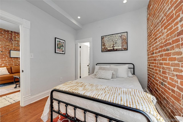 1208 S Pennsylvania St, Denver, CO 80210 - bedroom with brick wall, wood finished floors, recessed lighting, and baseboards