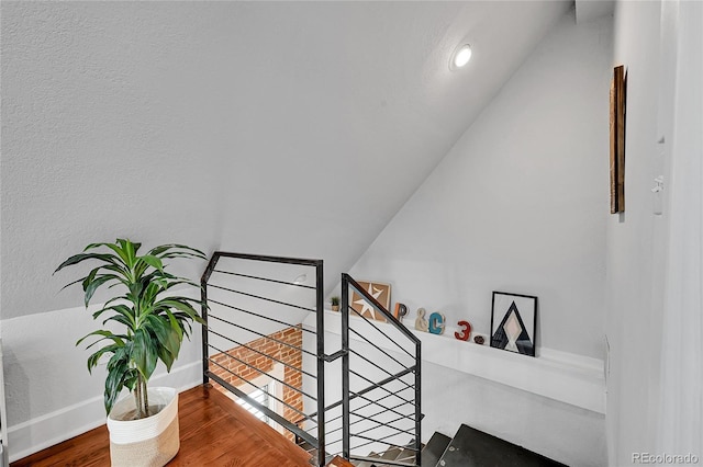 1208 S Pennsylvania St, Denver, CO 80210 - stairs with lofted ceiling, wood finished floors, and baseboards