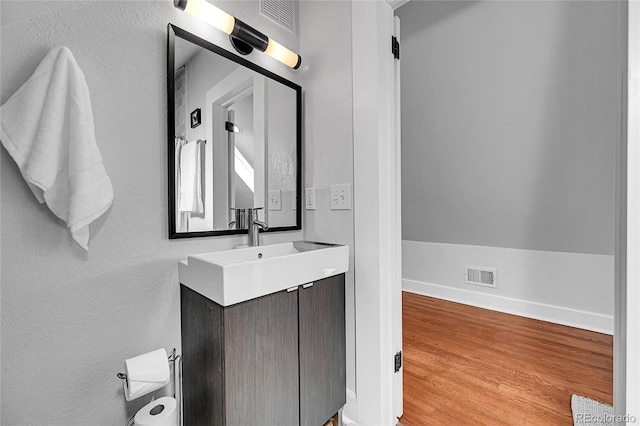 1208 S Pennsylvania St, Denver, CO 80210 - bathroom with vanity, baseboards, and wood finished floors