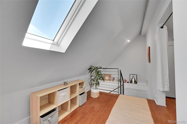 1208 S Pennsylvania St, Denver, CO 80210 - bedroom with wood finished floors, lofted ceiling, and a skylight
