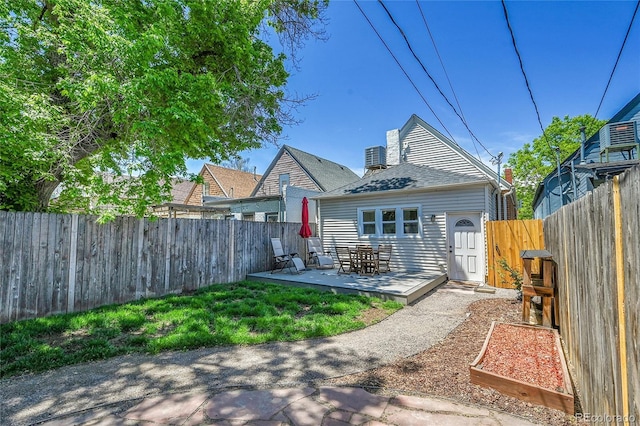 1208 S Pennsylvania St, Denver, CO 80210 - rear view of property with a fenced backyard and a deck