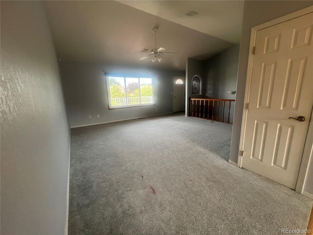 empty room with carpet, ceiling fan, and lofted ceiling