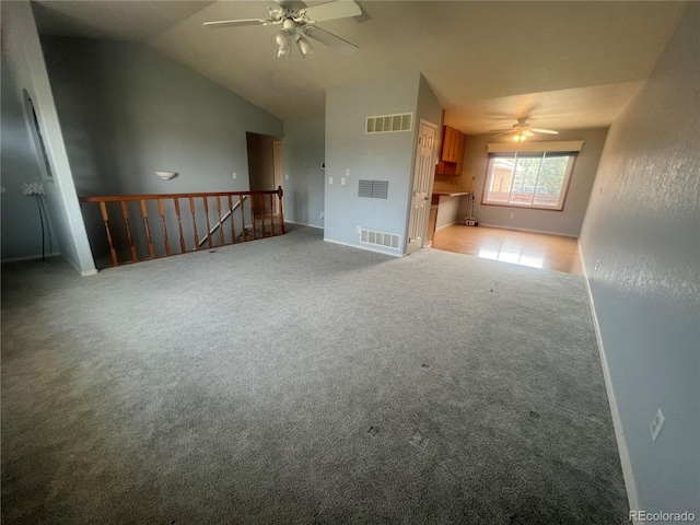 unfurnished living room with ceiling fan, light carpet, and vaulted ceiling