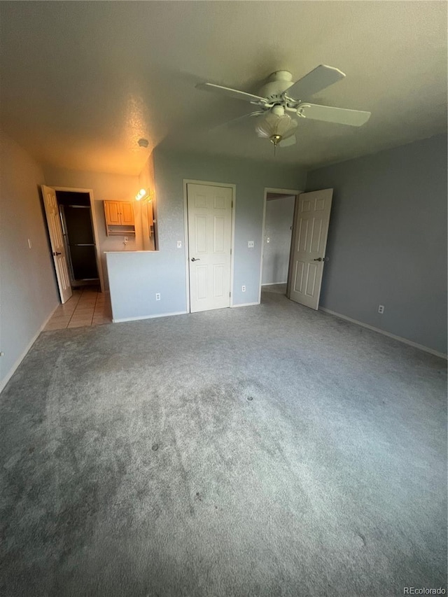 interior space with light colored carpet and ceiling fan