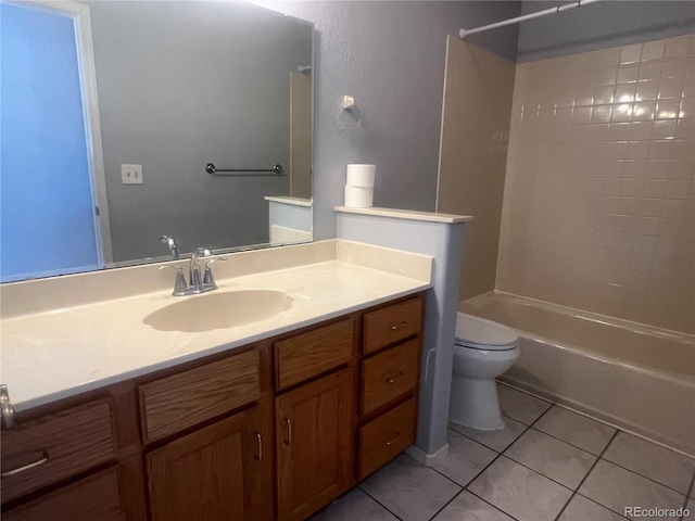 full bathroom featuring tile patterned floors, vanity, tiled shower / bath combo, and toilet